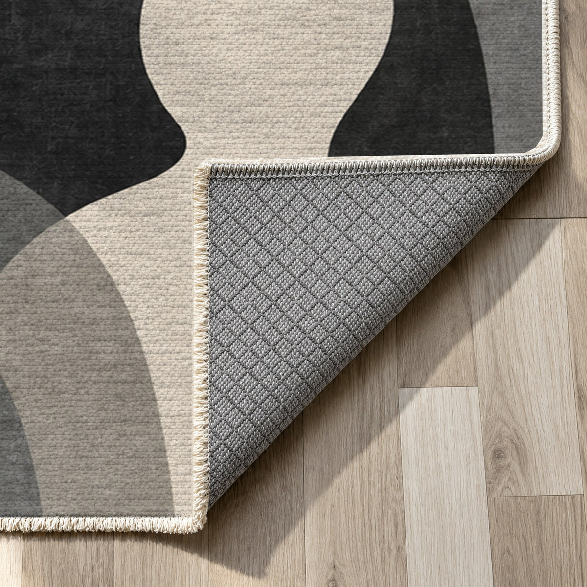 Gathering Shapes Charcoal Abstract Washable Rug — backing close up