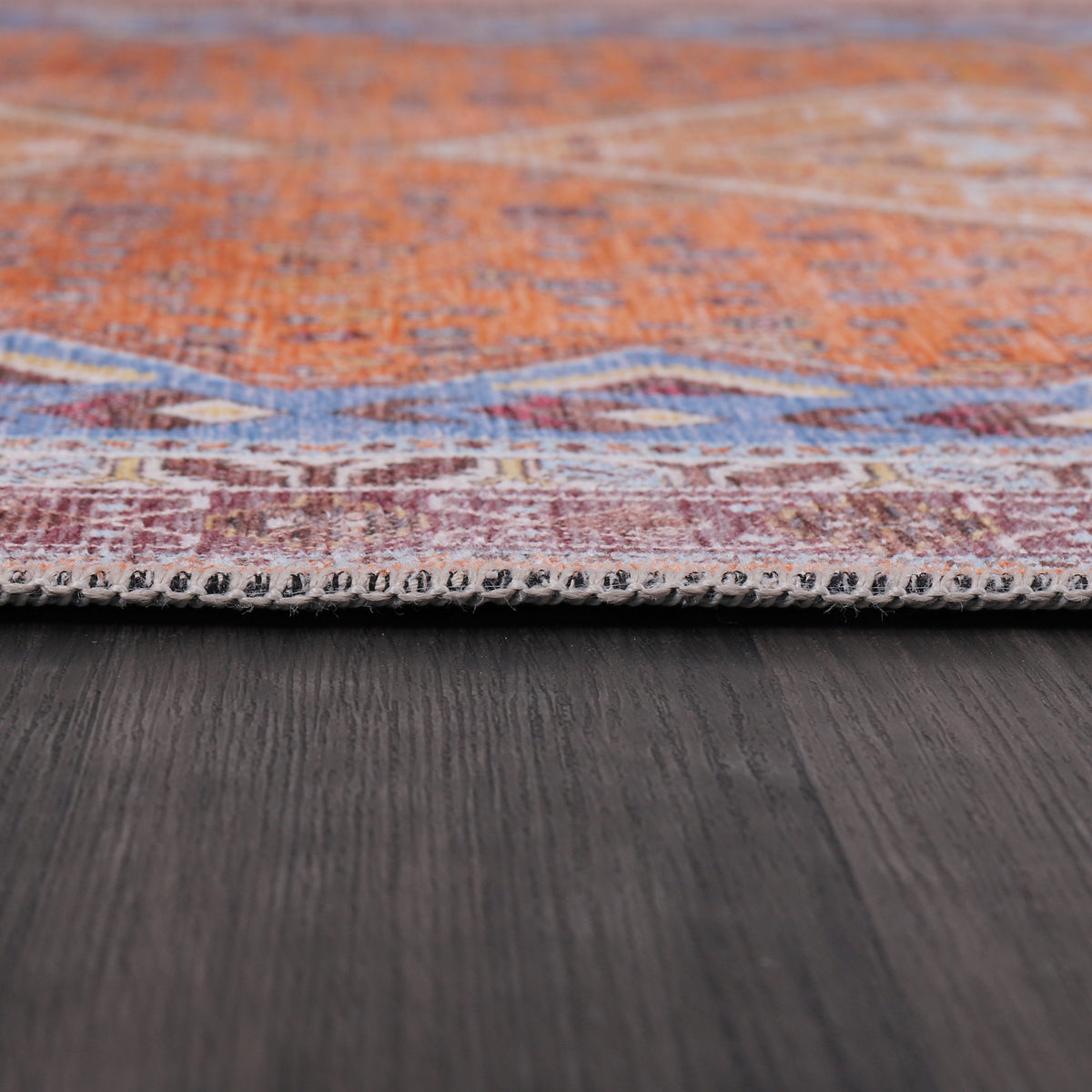 Germanica Washable R1 — washable r1 terracotta blue diamond tribal folded corner close up rug 17