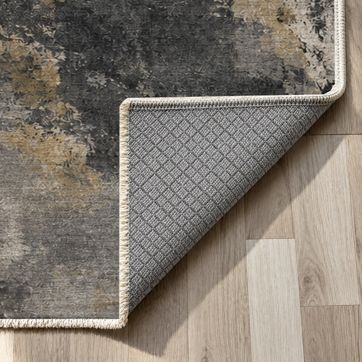 Ink River Charcoal Gold Abstract Washable Rug — backing close up