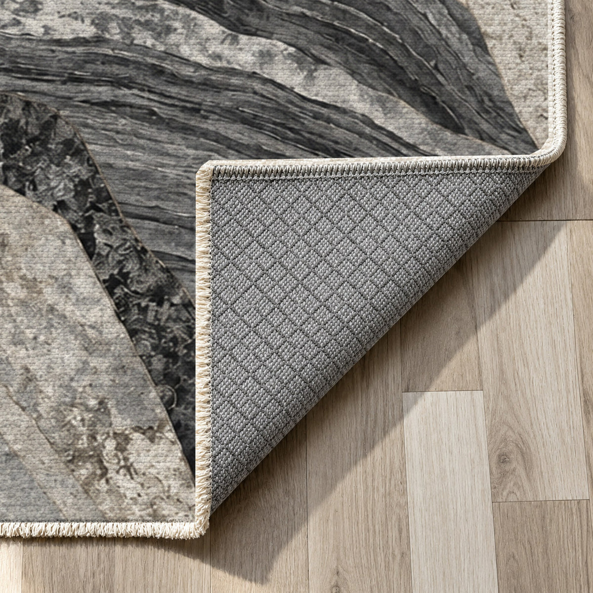 Mineral Fragments Charcoal Abstract Washable Rug — backing close up