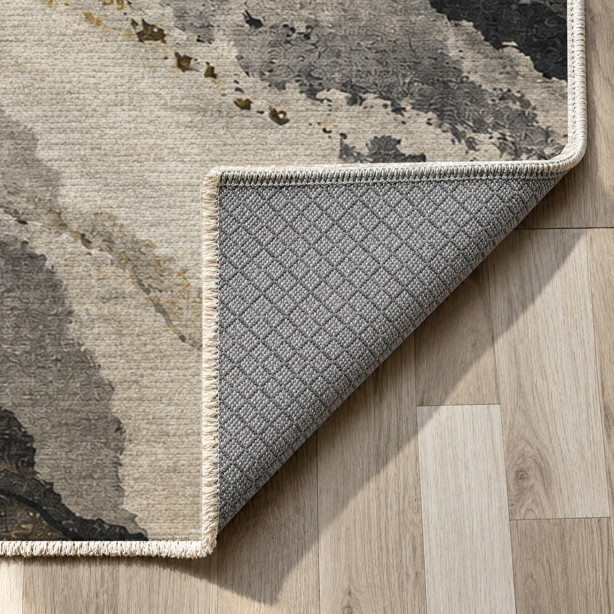 Tidal Traces Charcoal Gold Abstract Washable Rug — backing close up